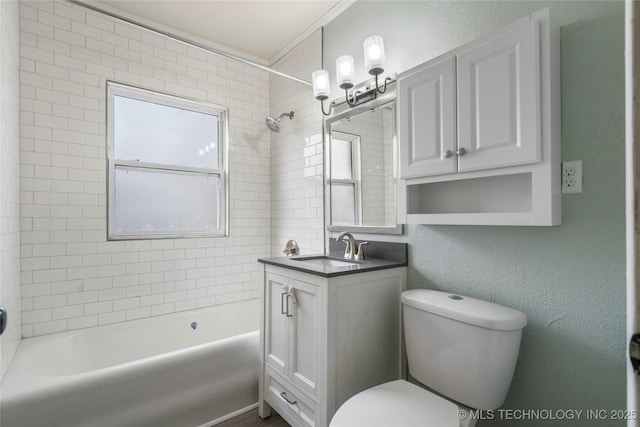 full bathroom with toilet, vanity, and tiled shower / bath