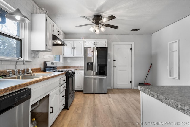 kitchen featuring pendant lighting, sink, white cabinetry, and appliances with stainless steel finishes