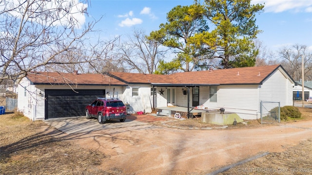 rear view of property with a garage and a porch