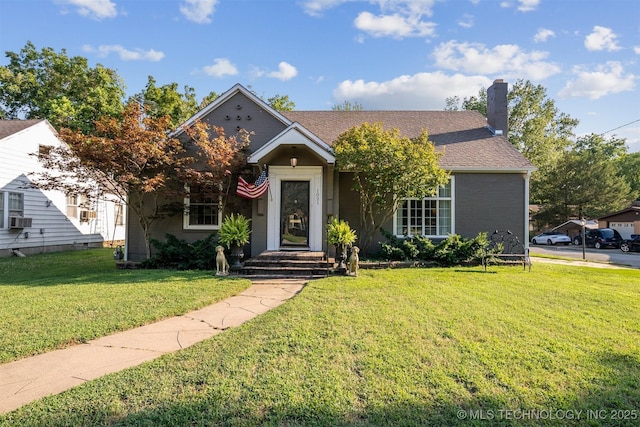 view of front of home with cooling unit and a front lawn