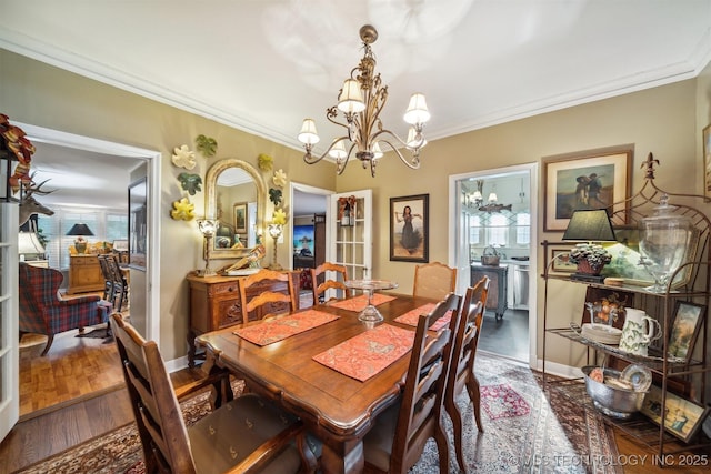 dining room featuring dark hardwood / wood-style flooring, crown molding, and a notable chandelier