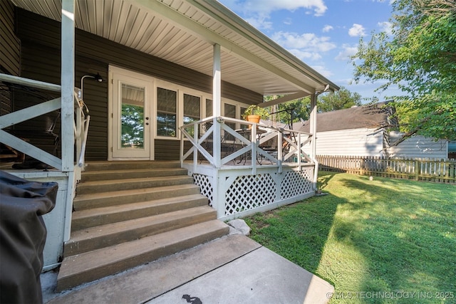 property entrance featuring a lawn