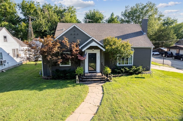 view of front facade with a front lawn and cooling unit