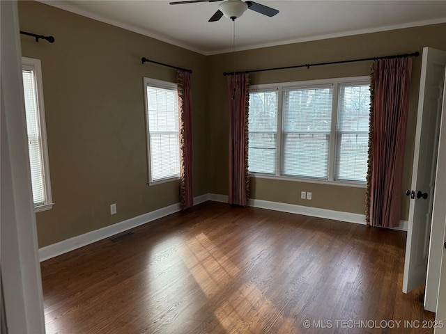 unfurnished room with dark wood-type flooring, ornamental molding, plenty of natural light, and ceiling fan