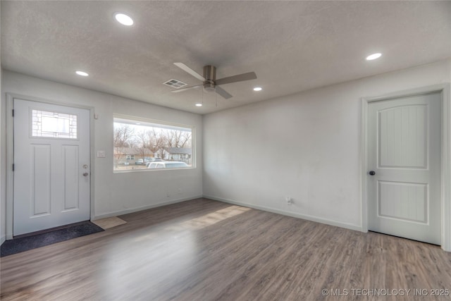 foyer entrance featuring a textured ceiling, ceiling fan, and hardwood / wood-style flooring