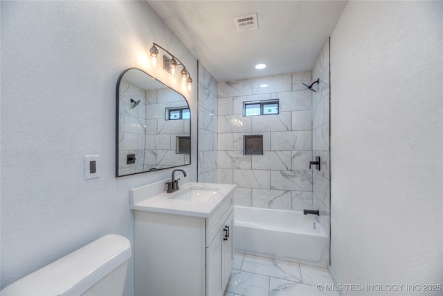 full bathroom with toilet, tiled shower / bath, and vanity