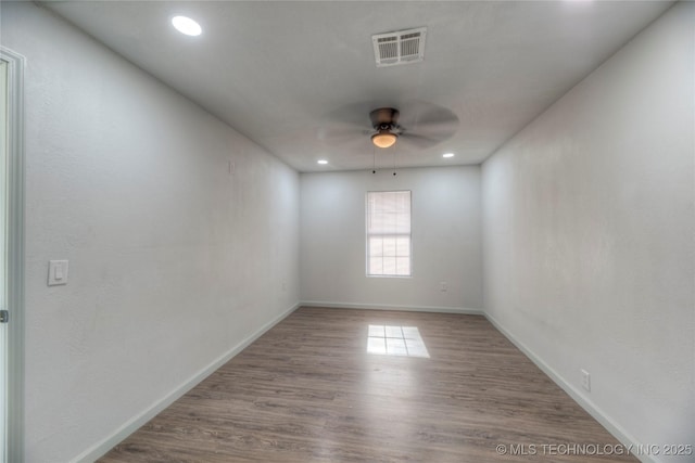 spare room with ceiling fan and wood-type flooring