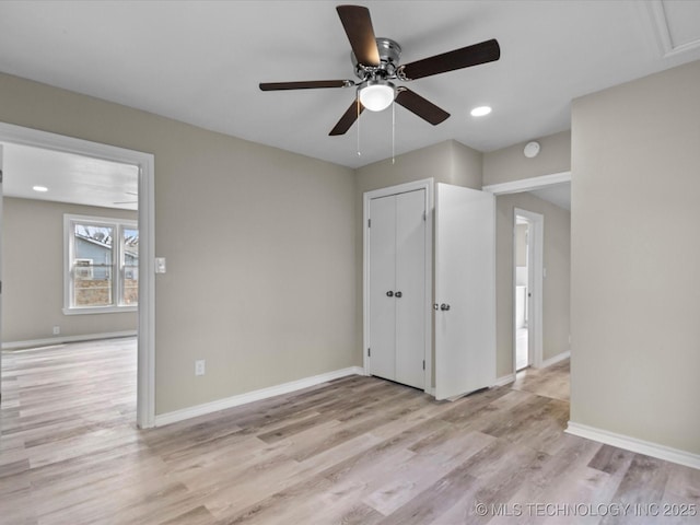 unfurnished bedroom with ceiling fan, a closet, and light wood-type flooring