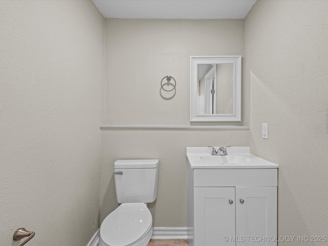 bathroom with toilet and vanity