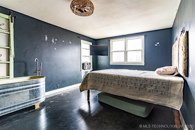 bedroom featuring a textured ceiling and hardwood / wood-style floors