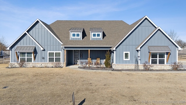 view of front facade with a front lawn and a porch