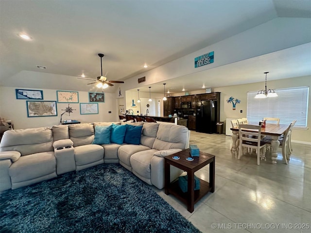 living room with ceiling fan and vaulted ceiling