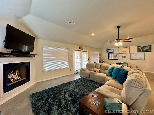 living room with ceiling fan, tile patterned floors, and lofted ceiling