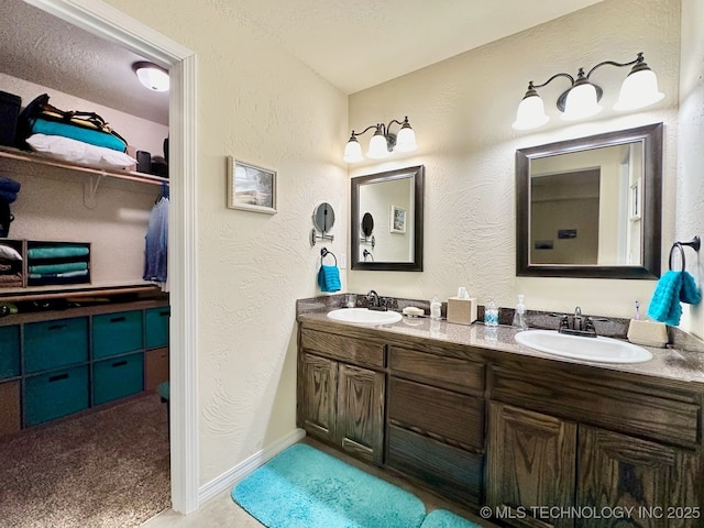 bathroom featuring a textured ceiling and vanity