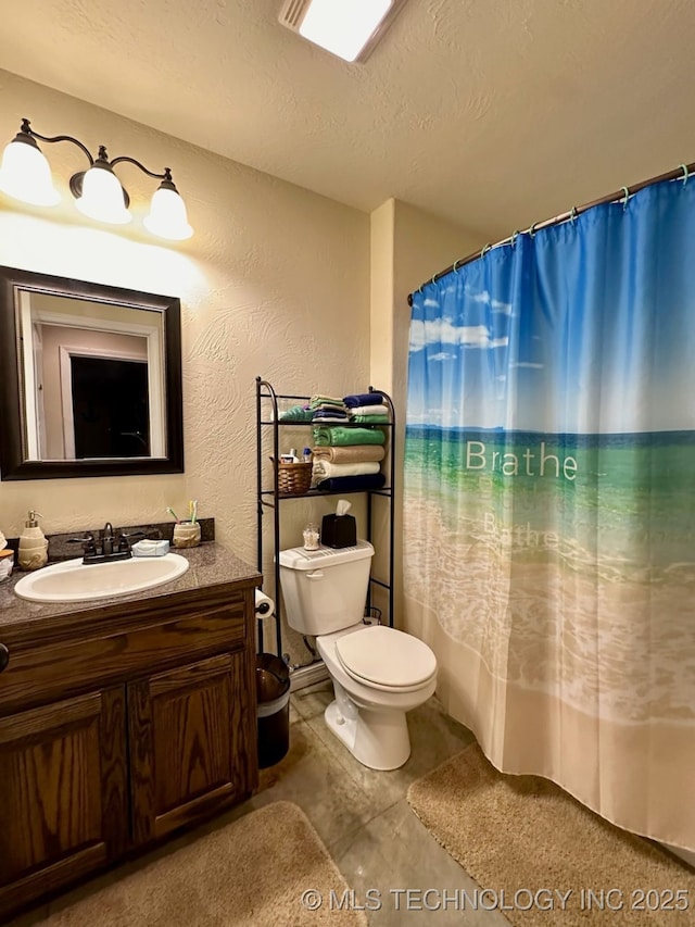 bathroom featuring a textured ceiling, toilet, vanity, and a shower with shower curtain