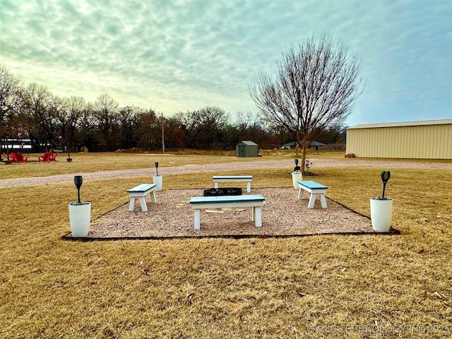 view of home's community featuring a yard and a storage unit