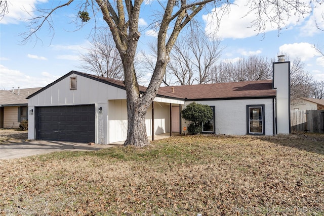 single story home featuring a front yard and a garage