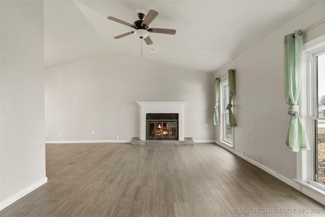 unfurnished living room with ceiling fan, vaulted ceiling, and dark hardwood / wood-style floors