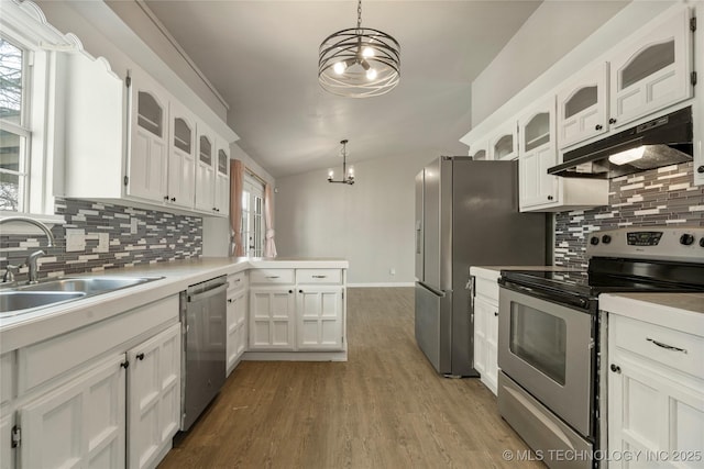 kitchen featuring appliances with stainless steel finishes, white cabinetry, hanging light fixtures, and sink