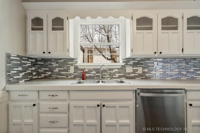 kitchen with white cabinetry, stainless steel dishwasher, backsplash, and sink