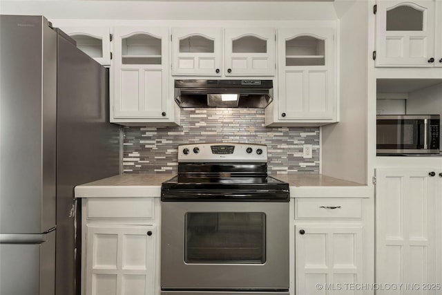 kitchen with appliances with stainless steel finishes, decorative backsplash, and white cabinetry