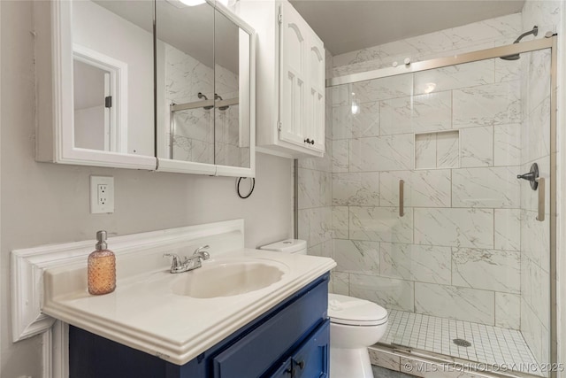 bathroom with an enclosed shower, vanity, and toilet