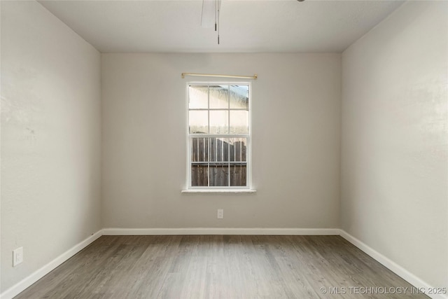 unfurnished room with hardwood / wood-style floors