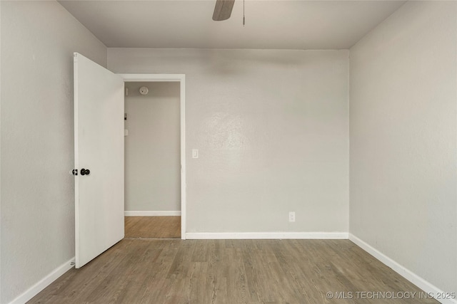 spare room with ceiling fan and hardwood / wood-style flooring