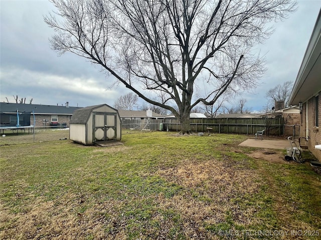 view of yard with a trampoline, a patio, and a shed