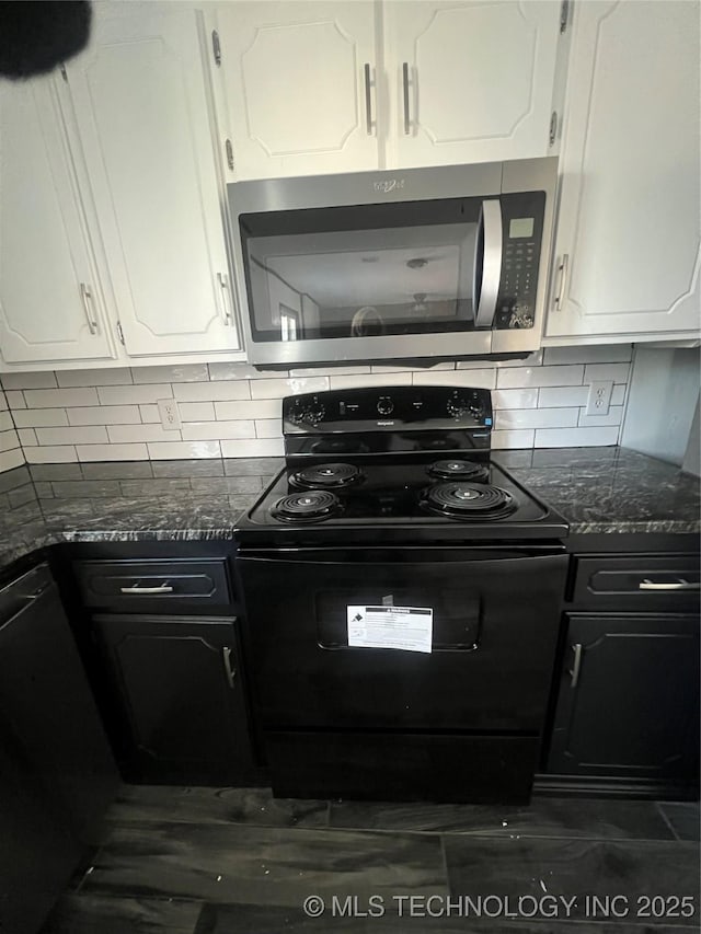 kitchen with decorative backsplash, white cabinets, black appliances, and dark stone counters