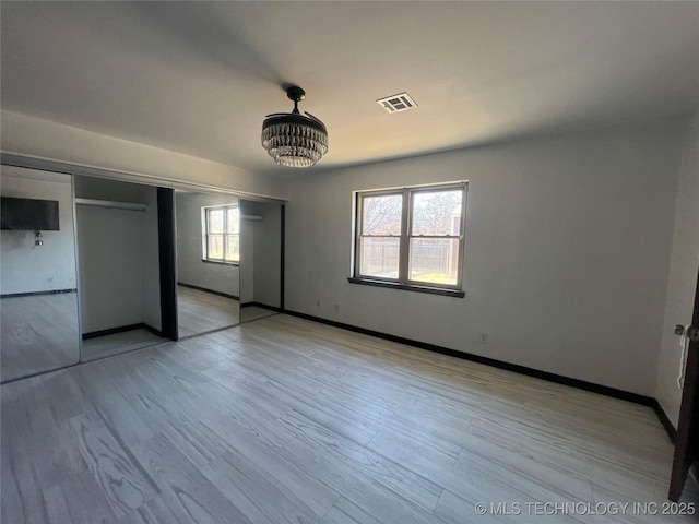 unfurnished bedroom with a closet and light hardwood / wood-style flooring