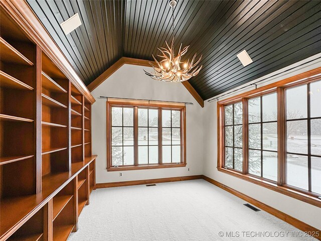 spare room featuring wood ceiling, carpet flooring, an inviting chandelier, and lofted ceiling