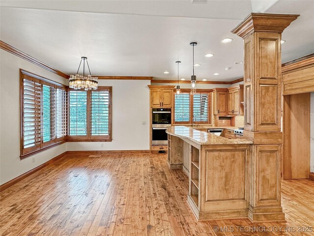 kitchen with decorative light fixtures, light hardwood / wood-style floors, ornamental molding, kitchen peninsula, and light stone counters