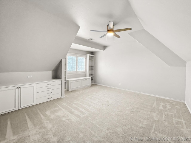 additional living space featuring vaulted ceiling, ceiling fan, and light colored carpet