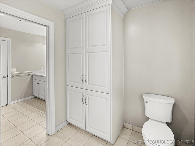 bathroom featuring tile patterned floors, vanity, and toilet