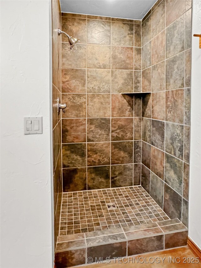 bathroom with a tile shower