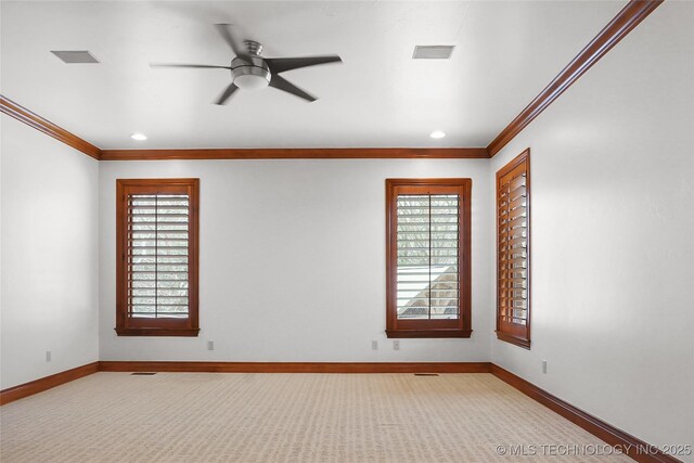 spare room featuring ceiling fan and ornamental molding