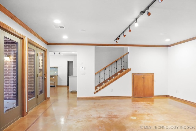 interior space featuring crown molding and rail lighting