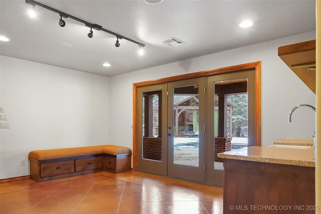 doorway to outside with sink, french doors, track lighting, and light tile patterned floors