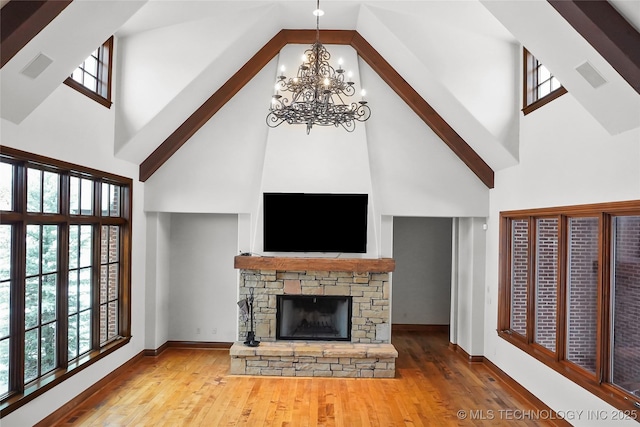 unfurnished living room with a fireplace, hardwood / wood-style floors, and a towering ceiling