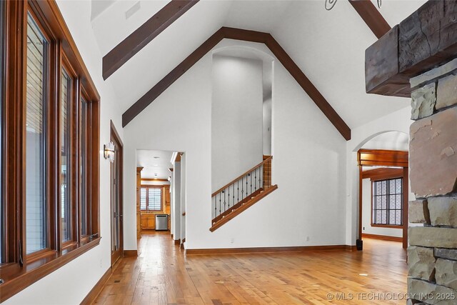 interior space with light hardwood / wood-style flooring and high vaulted ceiling