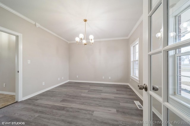 empty room featuring an inviting chandelier, dark hardwood / wood-style flooring, and crown molding