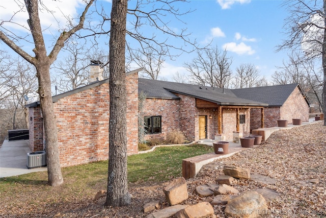 view of front of house featuring central AC unit and a patio