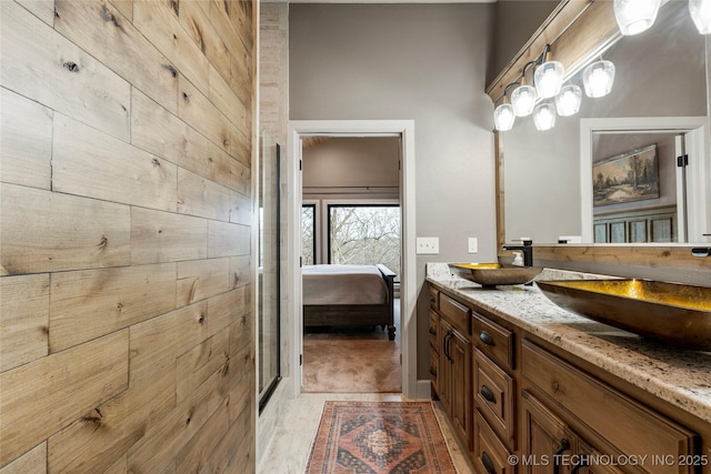 bathroom featuring vanity and wood walls