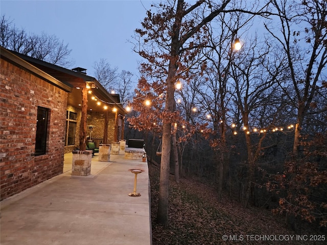 yard at dusk with a patio area