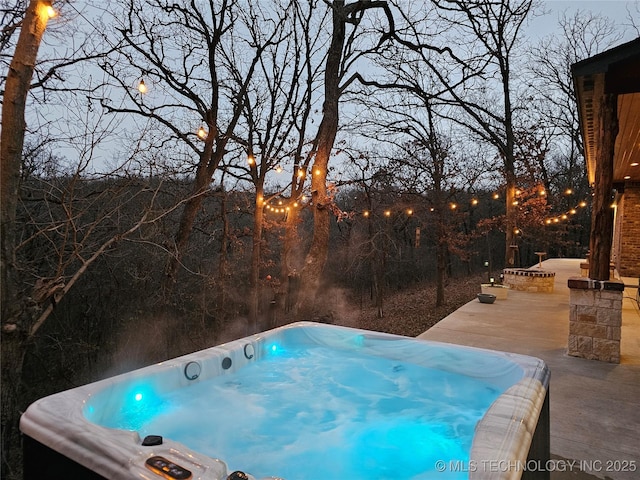 view of pool with a hot tub and a patio area