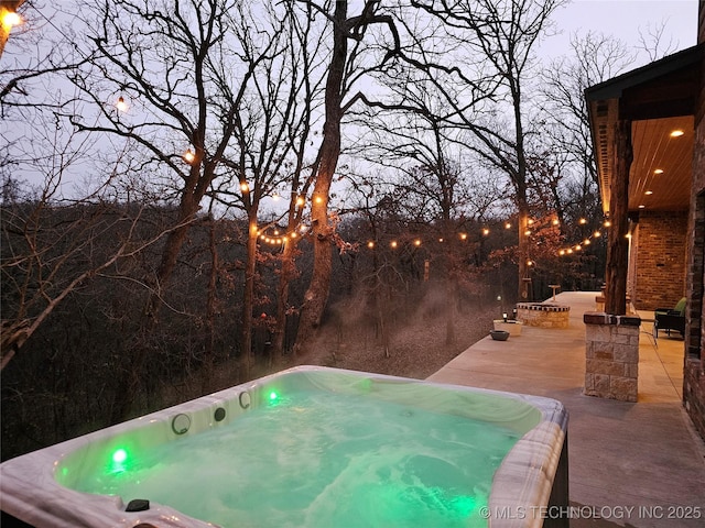 view of swimming pool with a patio area and a hot tub