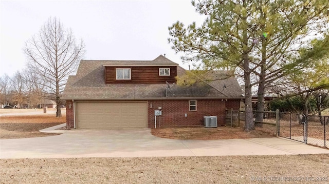 view of side of home with central AC and a garage