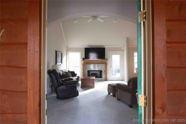 living room featuring lofted ceiling, ceiling fan, and carpet flooring