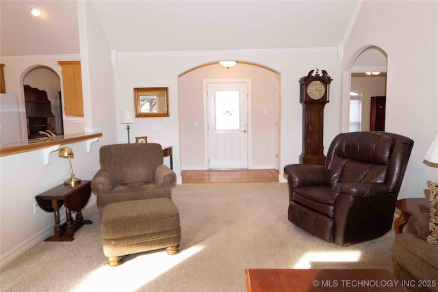 carpeted living room featuring ornamental molding